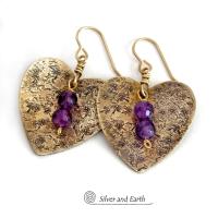 These gold brass heart earrings have a romantic, feminine charm and will make a great gift for someone special. They feature handcrafted gold brass hearts with a hand stamped texture accented with faceted amethyst gemstones dangling in front. The perfect gift to say "I love you" on Valentine's Day or any day! They'll also make a great gift for someone born in February - amethyst is the birthstone for this month.  Makes a great gift for couples celebrating their 21st wedding anniversary.