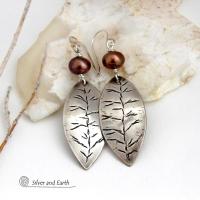These handcrafted sterling silver leaf earrings have a delicate hand stamped texture and are accented with bronze freshwater pearls. They have a modern, earthy elegance that coordinates beautifully with all wardrobe styles. They'll make a great gift for a nature lover. Handcrafted exclusively in the USA by Silver and Earth Jewelry, a New Mexico True Certified business.