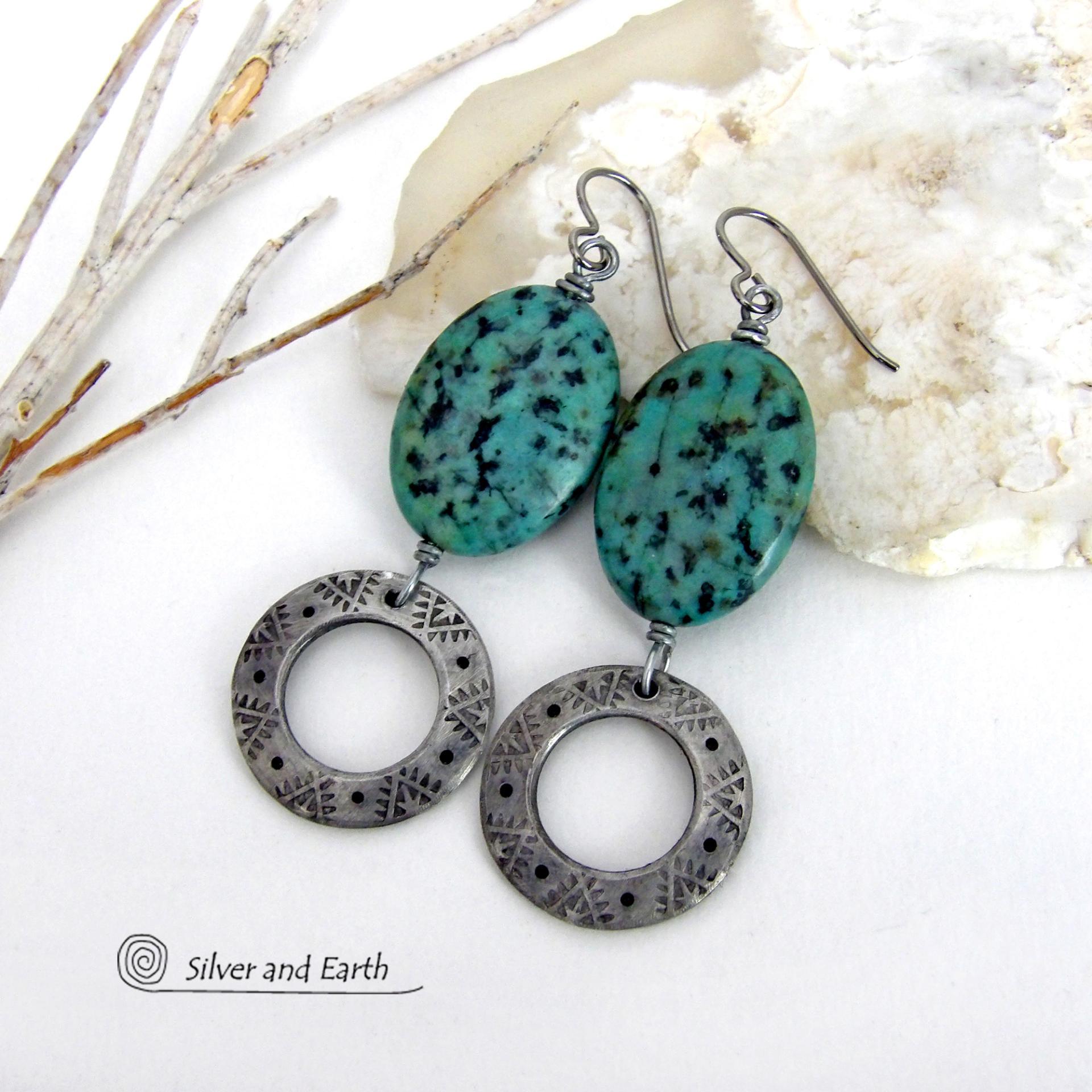 These handcrafted earrings feature natural African turquoise stones accented with silver tone pewter dangles with a hand stamped texture and oxidized finish. They have an earthy, modern style with a touch of southwestern flair. They have a coordinating necklace that is sold separately. Handmade in the USA by Silver and Earth Jewelry. 