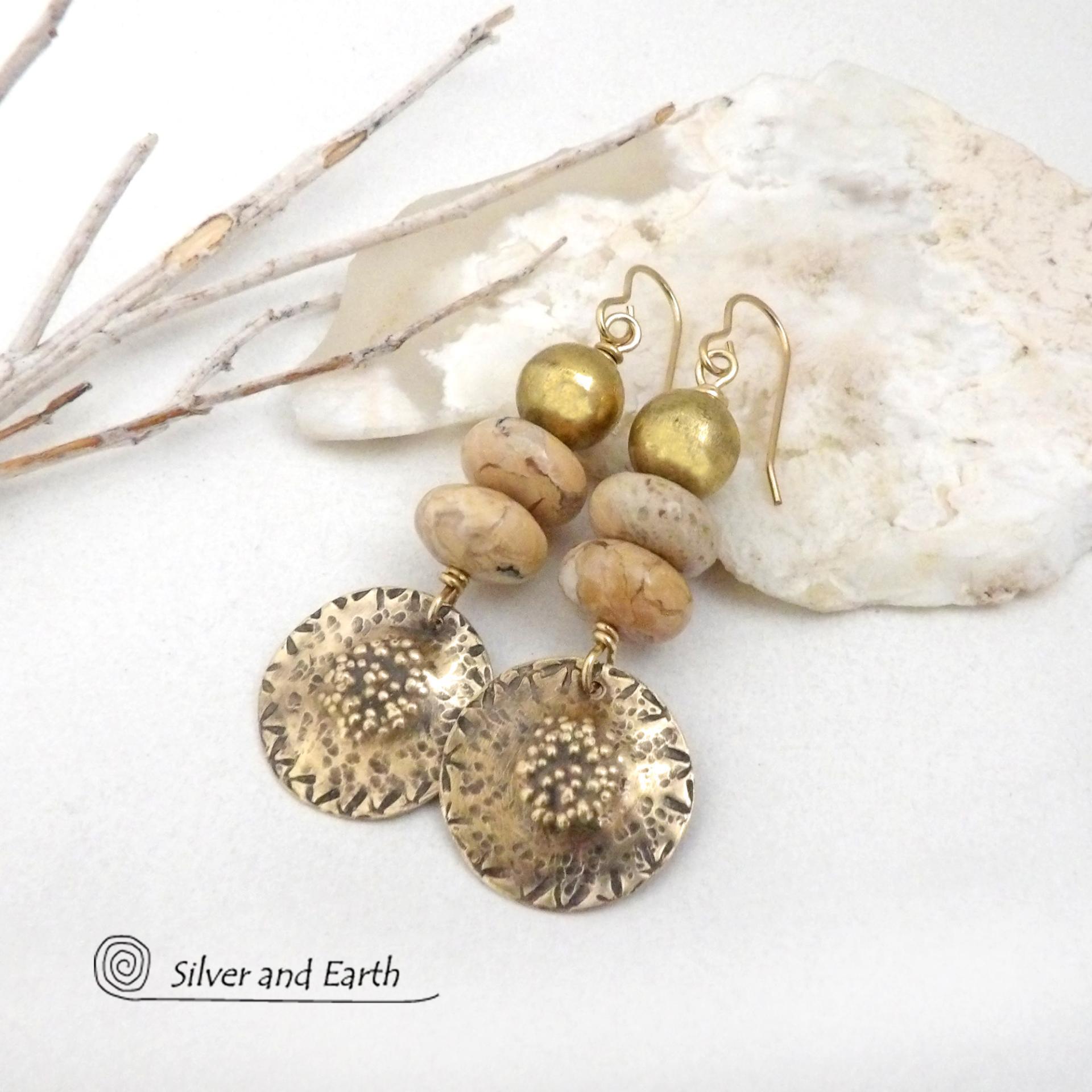 Creamy beige agate stones are accented with textured gold brass dangles and brass beads in these handcrafted earrings. The stones have a creamy beige and tan hue with a natural light brown speckled matrix. They have an earthy, modern style that coordinates beautifully with all wardrobe types.These artisan-made earrings showcase a unique blend of materials and craftsmanship. 