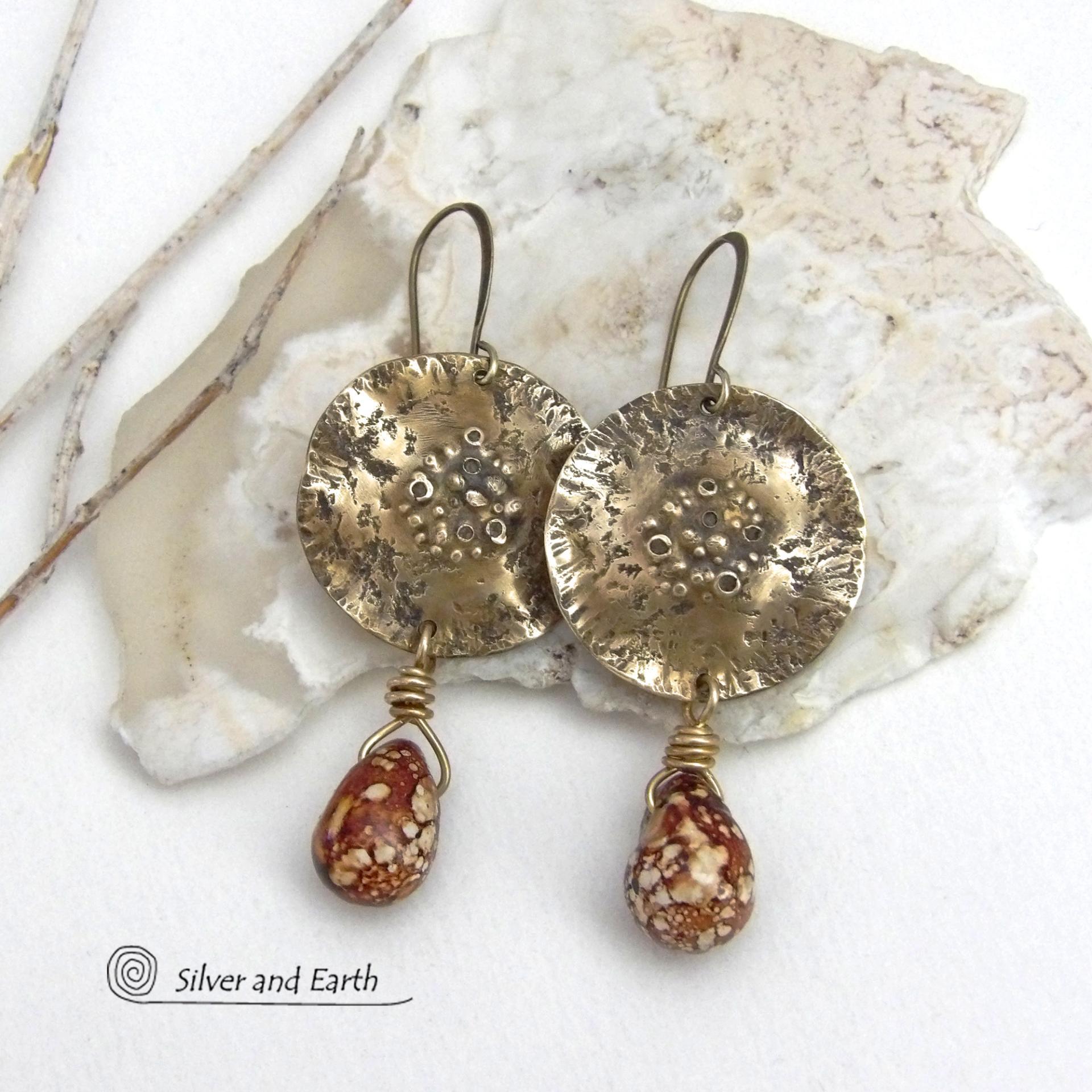These handcrafted gold brass earrings have a modern, organic earthy style and are accented with natural brown spotted jasper gemstones. Bold, unique and one-of-a-kind - they make a striking statement with a modern edgy vibe. Perfect for women that love unique artisan handcrafted jewelry, earthy hammered textures and natural stones. Handmade in the USA by Silver and Earth Jewelry.