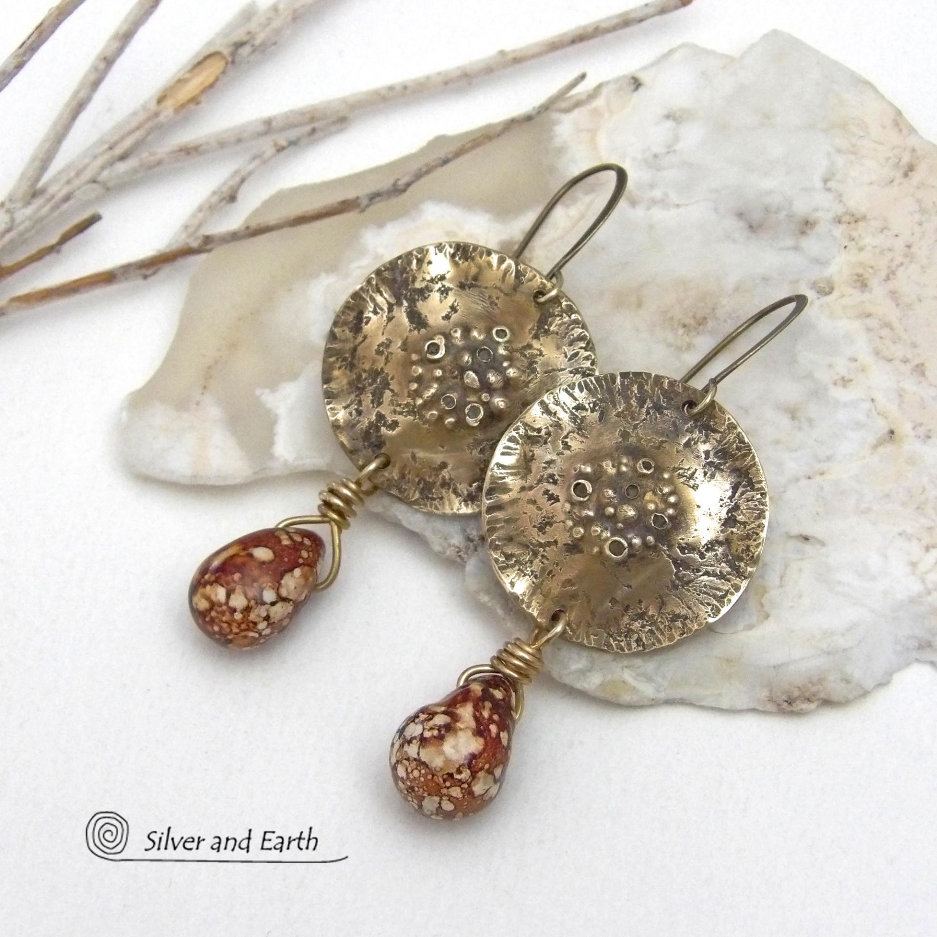 These handcrafted gold brass earrings have a modern, organic earthy style and are accented with natural brown spotted jasper gemstones. Bold, unique and one-of-a-kind - they make a striking statement with a modern edgy vibe. Perfect for women that love unique artisan handcrafted jewelry, earthy hammered textures and natural stones. Handmade in the USA by Silver and Earth Jewelry.