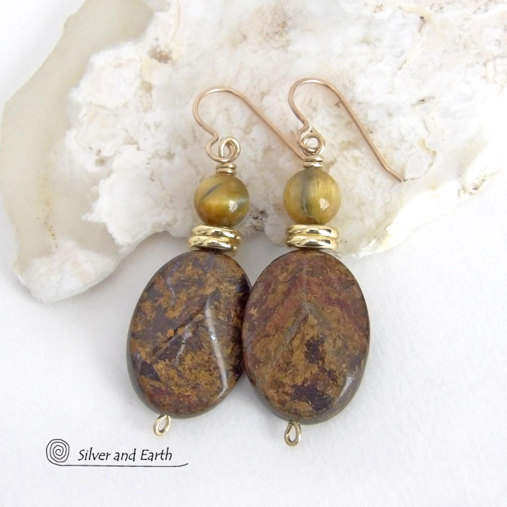 These handcrafted earrings feature natural bronzite gemstones with a faceted finish accented with golden tiger's eye gemstones and shiny brass beads. The bronzite stones have a beautiful chocolate brown hue with subtle *gold tone* metallic inclusions. Bronzite is a blend of several minerals which gives it a unique mottled appearance. They have a modern, earthy appeal and will make a great gift for a nature lover - or an interesting addition to your own jewelry wardrobe. Handmade in the USA by Silver and Ear