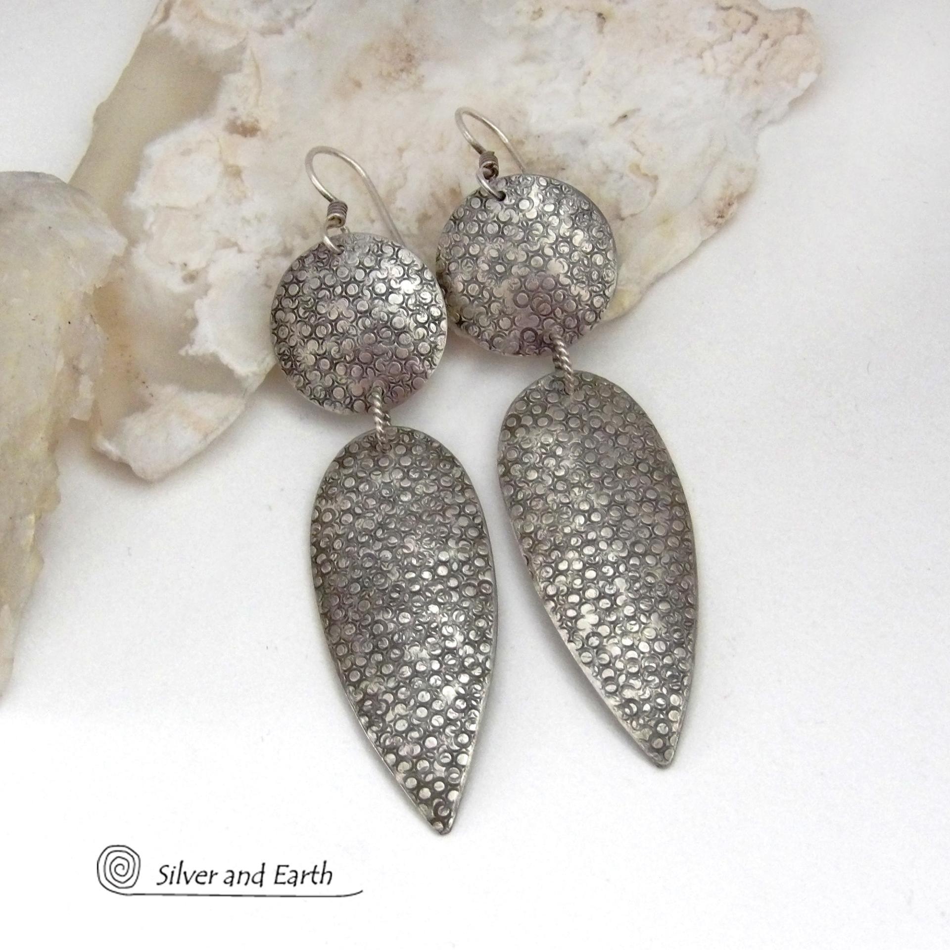 Bold, modern and contemporary - these long handcrafted sterling silver earrings feature an intricate hand textured design. They have an urban chic appeal and will look great with all wardrobe styles. They go with everything! Earrings are sturdy & substantial - yet lightweight and comfortable for all day wear.   MEASUREMENTS: Total length: 3" from top of sterling silver ear wires and 3/4” at widest point. Handmade in the USA by Silver and Earth Jewelry. 