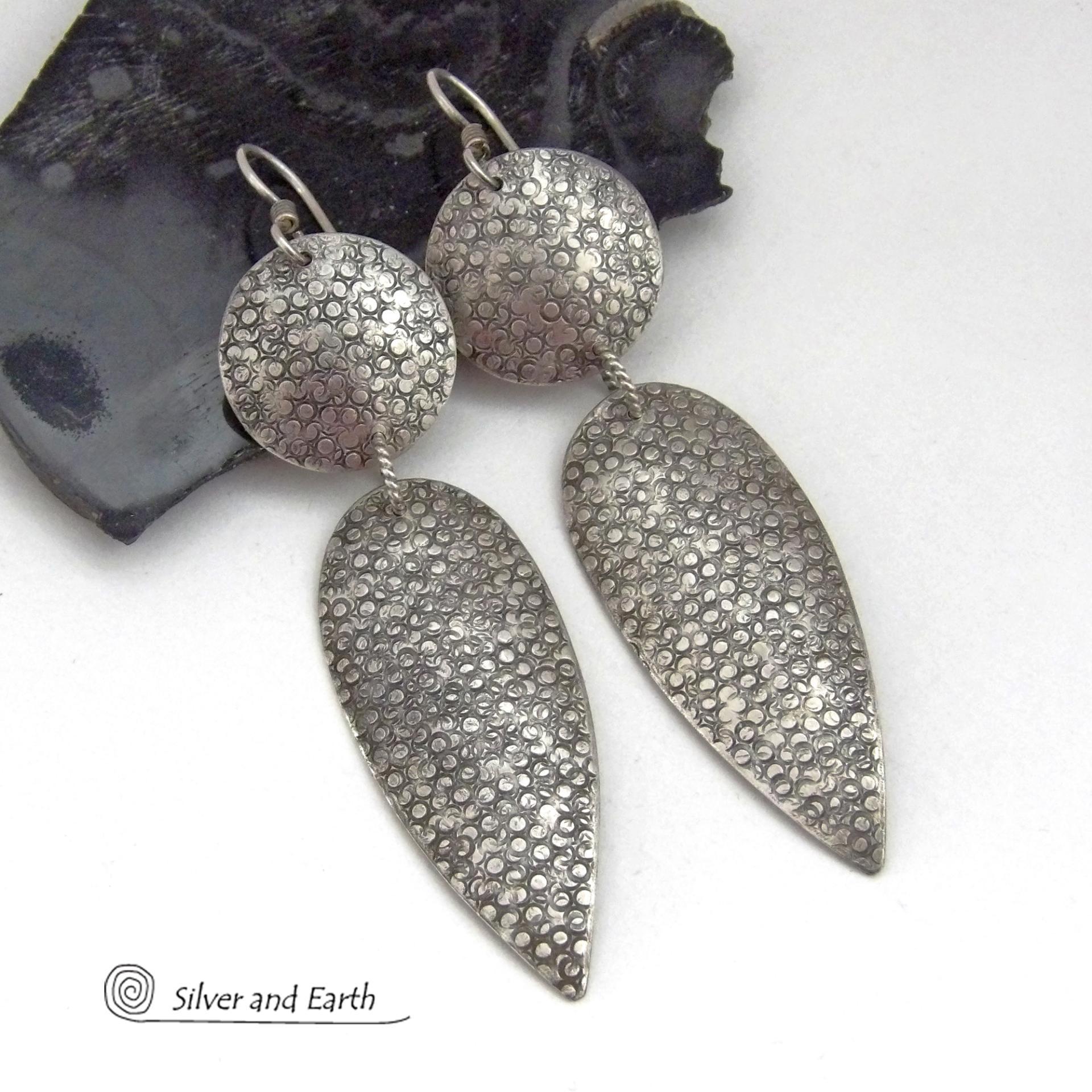 Bold, modern and contemporary - these long handcrafted sterling silver earrings feature an intricate hand textured design. They have an urban chic appeal and will look great with all wardrobe styles. They go with everything! Earrings are sturdy & substantial - yet lightweight and comfortable for all day wear.   MEASUREMENTS: Total length: 3" from top of sterling silver ear wires and 3/4” at widest point. Handmade in the USA by Silver and Earth Jewelry. 