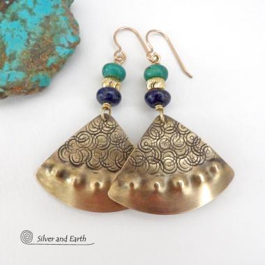 These handcrafted gold brass earrings have an exotic, Egyptian inspired vibe. The design consists of brass fan-shaped dangles with a hand textured design accented with lapis lazuli and turquoise gemstones and gold plated beads. Bold and unique, they'll add a touch of cultural exotic charm to any type of wardrobe. Handmade in the USA by Silver and Earth Jewelry. 