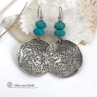 These handcrafted earrings feature large sterling silver round dangles with a hand stamped texture accented with natural turquoise gemstones with a faceted finish. Big and bold, they have a modern style with southwestern flair that looks great with all wardrobe types. Perfect for women that love large earrings and bold statement jewelry. Handmade in the USA by Silver and Earth Jewelry, a New Mexico True Certified business.