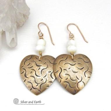 These handcrafted gold brass heart earrings have a hand stamped texture and are accented with white mother of pearl beads. They have a classic, modern style that coordinates beautifully with all wardrobe types. Full of romantic charm, they'll make a great gift for someone special on a birthday, wedding anniversary -- or any day! Makes a great gift for couples celebrating their 21st wedding anniversary - brass is the traditional choice for this occasion. 