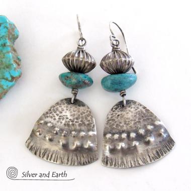 These handcrafted earrings feature uniquely textured sterling silver accented with natural turquoise gemstones and oxidized sterling silver beads with a rich, corrugated texture. They have a modern, southwestern tribal flair that makes a bold statement. Handmade in the USA by Silver and Earth Jewelry, a New Mexico True Certified business. 