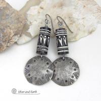 These silver pewter earrings have a rustic, hammered and hand stamped texture and are accented with handmade African tube-shaped beads with a striking black and white pattern. Bold and striking, they'll make a ethnic tribal statement. Perfect for women that unique and one of a kind artisan handcrafted jewelry. Handmade in the USA by Silver and Earth Jewelry.