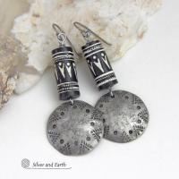 These silver pewter earrings have a rustic, hammered and hand stamped texture and are accented with handmade African tube-shaped beads with a striking black and white pattern. Bold and striking, they'll make a ethnic tribal statement. Perfect for women that unique and one of a kind artisan handcrafted jewelry. Handmade in the USA by Silver and Earth Jewelry.