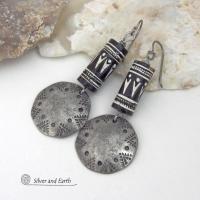 These silver pewter earrings have a rustic, hammered and hand stamped texture and are accented with handmade African tube-shaped beads with a striking black and white pattern. Bold and striking, they'll make a ethnic tribal statement. Perfect for women that unique and one of a kind artisan handcrafted jewelry. Handmade in the USA by Silver and Earth Jewelry.