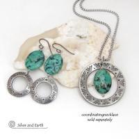 Unique and one-of-a-kind, these artisan handcrafted earrings feature natural African turquoise stones accented with silver tone pewter dangles with a hand stamped texture and oxidized finish. They have an earthy, modern style with a touch of southwestern flair. Coordinating necklace sold separately.