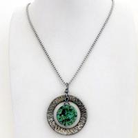 This handcrafted pendant necklace features a natural coin-shaped African turquoise gemstone framed against a hammered and oxidized silver tone pewter circle. It has a modern earthy organic style that coordinates well with all wardrobe types. The design is versatile and can be worn by either a man or woman. It will make a great gift for anyone that loves natural stone jewelry. Handmade in the USA by Silver and Earth Jewelry. 