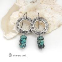 These handcrafted earrings feature oxidized silver pewter hoops with a rustic hammered and hand stamped texture accented with a stack of natural African turquoise stones. They have an earthy organic style with a modern, edgy vibe and are lightweight and comfortable to wear.