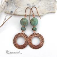  These handcrafted earrings feature round copper hoop dangles with a hand stamped texture accented with a stack of natural African turquoise stones and tiny copper beads. The stones have a pretty turquoise hue with an earthy natural black and brown matrix. These earrings have an earthy chic style with a modern bohemian flair that will coordinate beautifully with all wardrobe types. Handmade in the USA by Silver and Earth Jewelry.  Your choice of ear wires - copper or hypoallergenic niobium. 