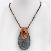 This pendant necklace features a beautiful aqua jasper gemstone with stunning hues of blue and brown accented with a hand forged copper bail with a lightly hammered texture. It's accented with twists of solid copper wire which forms a spiral in front. Unique and one-of-a-kind, it makes a great gift for a natural stone lover - or a nice addition to your own jewelry collection.
