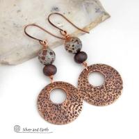These handcrafted earrings feature round copper hoop dangles with a rustic hand stamped texture accented with natural spotted asteroid jasper and bronze glass beads. Unique and striking, they have an earthy organic flair that makes a bold statement. The jasper stones have a great natural spotted pattern with earthy shades of chocolate brown and grey. Your choice of ear wires - copper or hypoallergenic niobium.