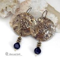 Big and bold - these handcrafted gold brass earrings have a modern chic contemporary style with an earthy, organic vibe that makes a bold, striking statement. They feature large brass circles with a rustic, organic hand textured design accented with dangling faceted black onyx gemstones and faceted hematite stones with a sparkly electroplated gold tone finish. Unique and striking, they have an earthy organic style with an exotic vibe that will look great dressed up or down. 