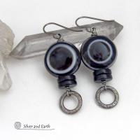 These earrings feature big natural black eye agate stones accented with black onyx and small hammered silver pewter circle dangles. When cut at the right angle, this type of agate reveals a series of concentric rings that resembles the human eye. They have a funky, modern vibe and are unique and fun to wear. They'll make a bold statement and are perfect for women that love to wear unique natural stone jewelry. 