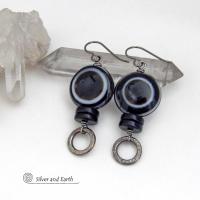 These earrings feature big natural black eye agate stones accented with black onyx and small hammered silver pewter circle dangles. When cut at the right angle, this type of agate reveals a series of concentric rings that resembles the human eye. They have a funky, modern vibe and are unique and fun to wear. They'll make a bold statement and are perfect for women that love to wear unique natural stone jewelry. 