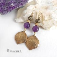 These handcrafted gold brass earrings have a hammered raw silk texture and are accented with natural purple amethyst gemstones, tiny brass beads and tulip flower-shaped brass beads. They have a modern elegant chic style that coordinates beautifully with all wardrobe types - dressed up or down. Makes a great gift for someone with a February birthday - amethyst is that month's birthstone. Handmade in the USA by Silver and Earth Jewelry. 