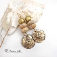 Creamy beige agate stones are accented with textured gold brass dangles and brass beads in these handcrafted earrings. The stones have a creamy beige and tan hue with a natural light brown speckled matrix. They have an earthy, modern style that coordinates beautifully with all wardrobe types.These handcrafted earrings showcase a unique blend of textures and patterns, perfect for adding a touch of bohemian style to any outfit. 