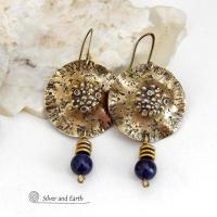 These handcrafted gold brass earrings have a rustic, hammered texture and are accented with dangling blue goldstones and small brass beads. They have a modern chic style with an earthy, organic vibe. Goldstone is a man-made stone of quartz sand glass infused with copper particles which creates the subtle sparkle effects. It was invented in Venice, Italy in the seventeenth century. Handmade in the USA by Silver and Earth Jewelry. 