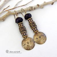 Bold and unique, these handcrafted earrings have an ethnic African tribal vibe. They feature gold brass dangles with a hand stamped and lightly hammered background texture accented with African beads with an intricately carved brownish-black and tan pattern topped off with black African carved bone beads. Unique and fun to wear - they'll make a bold, striking statement. Perfect for women that love to wear one-of-a-kind artisan handcrafted jewelry. Handmade in the USA by Silver and Earth Jewelry.