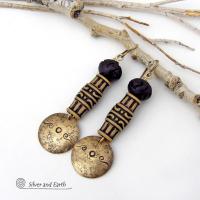 Bold and unique, these handcrafted earrings have an ethnic African tribal vibe. They feature gold brass dangles with a hand stamped and lightly hammered background texture accented with African beads with an intricately carved brownish-black and tan pattern topped off with black African carved bone beads. Unique and fun to wear - they'll make a bold, striking statement. Perfect for women that love to wear one-of-a-kind artisan handcrafted jewelry. Handmade in the USA by Silver and Earth Jewelry.