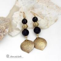 These handcrafted earrings feature gold brass dangles with a hammered raw silk texture accented with black onyx gemstones and brass beads. They have a modern boho chic style with a touch of Egyptian inspired flair that coordinates beautifully with all wardrobe types. Perfect for women that love artisan handcrafted jewelry that makes a bold statement. Handmade in the USA by Silver and Earth Jewelry. 