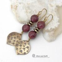 These handcrafted gold brass earrings have a hand stamped texture accented with micro-faceted deep burgundy mookaite gemstones and faceted hematite stone beads with an electroplated champagne gold tone finish. Mookaite is a unique, colorful type of jasper found at the Mooka Creek in Western Australia. These earrings have an elegant modern chic style that coordinates beautifully with all wardrobe types - dressed up or down. Handmade in the USA by Silver and Earth Jewelry.
