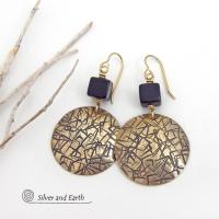 Artisan handcrafted round gold brass earrings with a hand-stamped abstract texture accented with cube-shaped matte black jasper stones on top. They have a modern contemporary vibe that coordinates beautifully with all wardrobe styles.