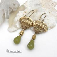 Bold and unique, these handcrafted earrings have an exotic bohemian style with a touch of Egyptian flair. They feature gold brass with a hammered and stamped texture accented with teardrop-shaped natural green jade gemstones and brass beads. Perfect for women that love to wear unique artisan handcrafted jewelry. Total length of approximately 2-3/8" from top of brass ear wires and 1" at widest point. Handmade in the USA by Silver and Earth Jewelry. 