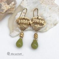 Bold and unique, these handcrafted earrings have an exotic bohemian style with a touch of Egyptian flair. They feature gold brass with a hammered and stamped texture accented with teardrop-shaped natural green jade gemstones and brass beads. Perfect for women that love to wear unique artisan handcrafted jewelry. Total length of approximately 2-3/8" from top of brass ear wires and 1" at widest point. Handmade in the USA by Silver and Earth Jewelry. 