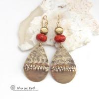 These gold brass teardrop dangle earrings have a unique hand textured design and are accented with faceted red coral and brass beads. They have an exotic, boho chic vibe that makes a bold modern statement.