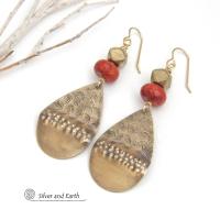 These gold brass teardrop dangle earrings have a unique hand textured design and are accented with faceted red coral and brass beads. They have an exotic, boho chic vibe that makes a bold modern statement.