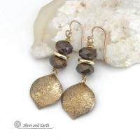 These handcrafted earrings feature gold brass dangles with a hammered organic texture accented with natural bronzite gemstones and shiny gold brass beads. The stones have a beautiful brown hue with a faceted finish which casts off a natural sparkle and shine. They have a modern chic style that coordinates beautifully with all wardrobe types - dressed up or down. A coordinating necklace is available that is sold separately.  Handmade in the USA by Silver and Earth Jewelry.