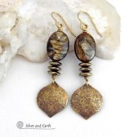 These handcrafted earrings feature gold brass dangles with a hammered organic texture accented with natural brown mica gemstones and faceted hematite stones with an electroplated champagne gold finish. The stones have a beautiful brown hue with undertones of shimmery gold and a faceted finish which casts off a natural sparkle and shine. They have a modern, chic and elegant style that coordinates beautifully with all wardrobe types - dressed up or down. Handmade in the USA by Silver and Earth Jewelry.