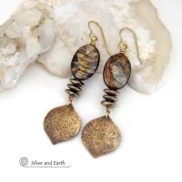 These handcrafted earrings feature gold brass dangles with a hammered organic texture accented with natural brown mica gemstones and faceted hematite stones with an electroplated champagne gold finish. The stones have a beautiful brown hue with undertones of shimmery gold and a faceted finish which casts off a natural sparkle and shine. They have a modern, chic and elegant style that coordinates beautifully with all wardrobe types - dressed up or down.