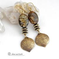 These handcrafted earrings feature gold brass dangles with a hammered organic texture accented with natural brown mica gemstones and faceted hematite stones with an electroplated champagne gold finish. The stones have a beautiful brown hue with undertones of shimmery gold and a faceted finish which casts off a natural sparkle and shine. They have a modern, chic and elegant style that coordinates beautifully with all wardrobe types - dressed up or down.