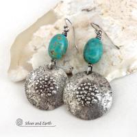These handcrafted earrings feature natural turquoise nuggets accented with round sterling silver dangles with a rustic hammered and stamped texture. The stones are a gorgeous shade of turquoise with a subtle natural copper matrix. They have a modern, earthy organic style with a touch of southwestern flair.