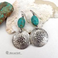 These handcrafted earrings feature natural turquoise nuggets accented with round sterling silver dangles with a rustic hammered and stamped texture. The stones are a gorgeous shade of turquoise with a subtle natural copper matrix. They have a modern, earthy organic style with a touch of southwestern flair. Handmade by Silver and Earth, a New Mexico True Certified Business.