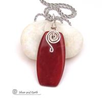 This handcrafted carnelian gemstone necklace has a modern chic flair. It features a natural carnelian gemstone with a dark burnt orange hue accented with a hand forged sterling silver spiral accent and sterling silver wire bail. 