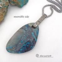 This one-of-a-kind necklace features a gorgeous, large chunky chrysocolla in quartz gemstone. The stone has beautiful shades of blue and brown within a quartz base. It hangs from a hand forged solid sterling silver bail with a lightly hammered organic texture. The stone is equally gorgeous on both sides, so I designed it to be reversible. (See all photos for alternate sides). Big and bold, it's sure to make a statement. Makes a great gift for a natural stone lover - or a nice addition to your own jewelry wa