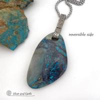 This one-of-a-kind necklace features a gorgeous, large chunky chrysocolla in quartz gemstone. The stone has beautiful shades of blue and brown within a quartz base. It hangs from a hand forged solid sterling silver bail with a lightly hammered organic texture. The stone is equally gorgeous on both sides, so I designed it to be reversible. (See all photos for alternate sides). Big and bold, it's sure to make a statement. Makes a great gift for a natural stone lover - or a nice addition to your own jewelry wa