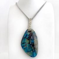 This one-of-a-kind necklace features a gorgeous, large chunky chrysocolla in quartz gemstone. The stone has beautiful shades of blue and brown within a quartz base. It hangs from a hand forged solid sterling silver bail with a lightly hammered organic texture. The stone is equally gorgeous on both sides, so I designed it to be reversible. (See all photos for alternate sides). Big and bold, it's sure to make a statement. Makes a great gift for a natural stone lover - or a nice addition to your own jewelry wa