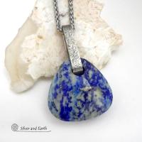 This one-of-a-kind necklace features a gorgeous, chunky and thick natural lapis lazuli gemstone accented with a handcrafted sterling silver bail with a lightly hammered organic texture. The stone is a beautiful shade of blue with white inclusions and a sprinkling of natural sparkly pyrite inclusions and a faceted finish. The stone is equally gorgeous on both sides, so I designed it to be reversible. (See all photos for alternate sides). Handmade in the USA by Silver and Earth Jewelry.