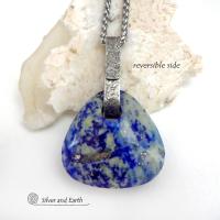 This one-of-a-kind necklace features a gorgeous, chunky and thick natural lapis lazuli gemstone accented with a handcrafted sterling silver bail with a lightly hammered organic texture. The stone is a beautiful shade of blue with white inclusions and a sprinkling of natural sparkly pyrite inclusions and a faceted finish. The stone is equally gorgeous on both sides, so I designed it to be reversible. (See all photos for alternate sides). Handmade in the USA by Silver and Earth Jewelry.