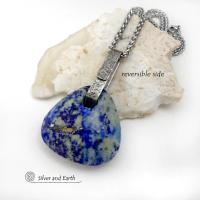 This one-of-a-kind necklace features a gorgeous, chunky and thick natural lapis lazuli gemstone accented with a handcrafted sterling silver bail with a lightly hammered organic texture. The stone is a beautiful shade of blue with white inclusions and a sprinkling of natural sparkly pyrite inclusions and a faceted finish. The stone is equally gorgeous on both sides, so I designed it to be reversible. (See all photos for alternate sides). Pendant comes on a 20" stainless steel chain necklace. 